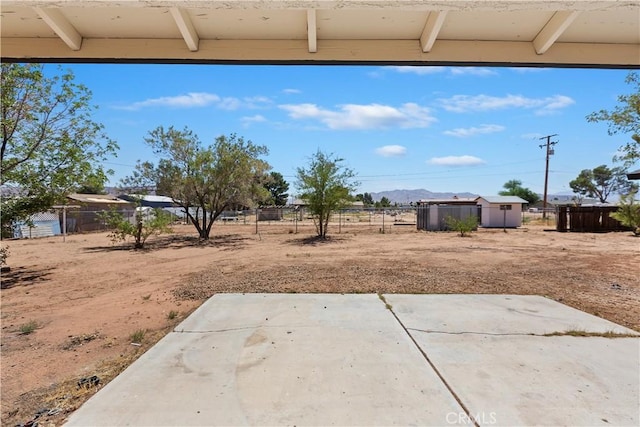 15615 Erie Rd, Apple Valley, CA 92307 - fenced backyard featuring a patio area and a mountain view
