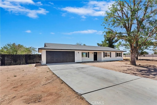 15615 Erie Rd, Apple Valley, CA 92307 - single story home featuring a garage, driveway, and stucco siding