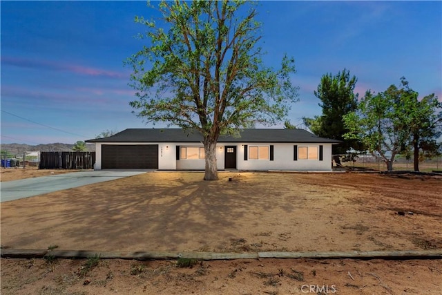 15615 Erie Rd, Apple Valley, CA 92307 - ranch-style house featuring concrete driveway, a garage, and stucco siding