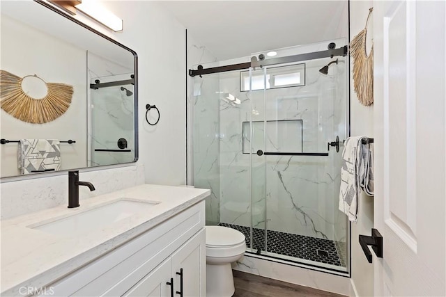 15615 Erie Rd, Apple Valley, CA 92307 - bathroom with a marble finish shower, vanity, and wood finished floors
