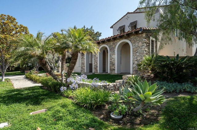 7425 Rancho Cabrillo Trl, San Diego, CA 92127 - mediterranean / spanish home with stone siding, stucco siding, and a front lawn