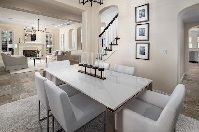 7425 Rancho Cabrillo Trl, San Diego, CA 92127 - dining area featuring arched walkways, stone tile floors, and healthy amount of natural light
