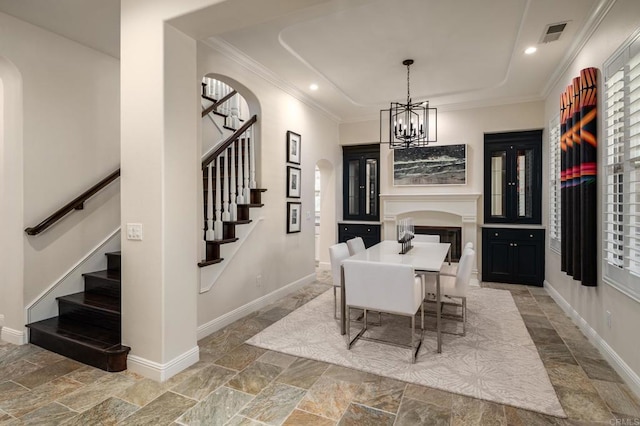7425 Rancho Cabrillo Trl, San Diego, CA 92127 - dining room featuring arched walkways, stairway, stone tile floors, ornamental molding, and a chandelier