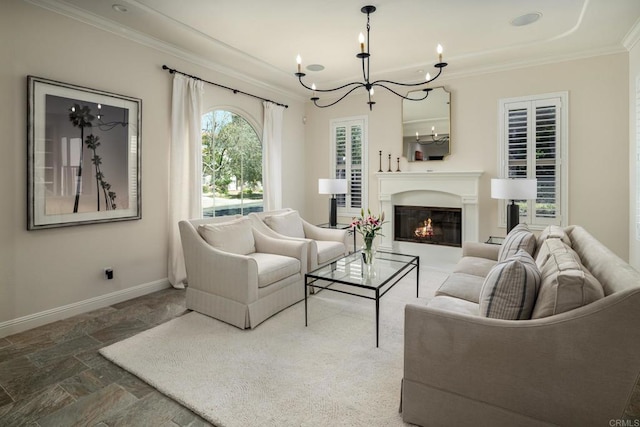 7425 Rancho Cabrillo Trl, San Diego, CA 92127 - living room with ornamental molding, a chandelier, stone finish flooring, and a glass covered fireplace
