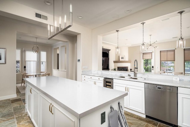 7425 Rancho Cabrillo Trl, San Diego, CA 92127 - kitchen featuring stainless steel dishwasher, wine cooler, light countertops, crown molding, and white cabinets