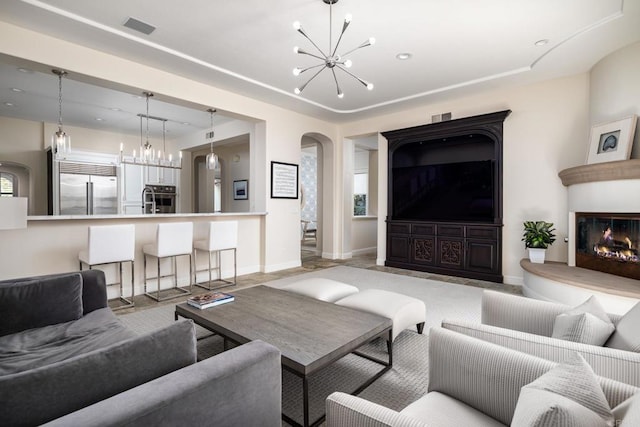 7425 Rancho Cabrillo Trl, San Diego, CA 92127 - living room with a chandelier, arched walkways, and a large fireplace