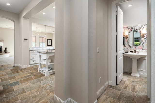 7425 Rancho Cabrillo Trl, San Diego, CA 92127 - hallway with stone tile floors, arched walkways, and recessed lighting
