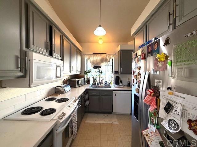 911 Concord Ct, Vista, CA 92081 - kitchen with white appliances, light countertops, gray cabinets, and pendant lighting