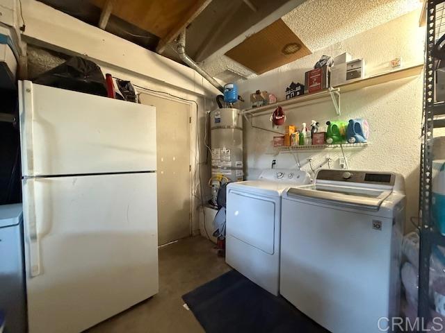 911 Concord Ct, Vista, CA 92081 - washroom with strapped water heater, washer and clothes dryer, and a textured wall