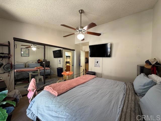 911 Concord Ct, Vista, CA 92081 - carpeted bedroom featuring vaulted ceiling, a textured ceiling, ceiling fan, and a closet