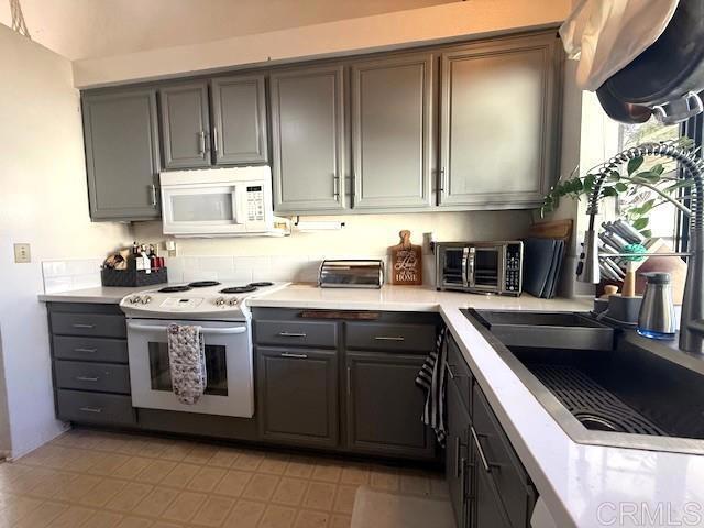 911 Concord Ct, Vista, CA 92081 - kitchen with white appliances, gray cabinets, and light countertops