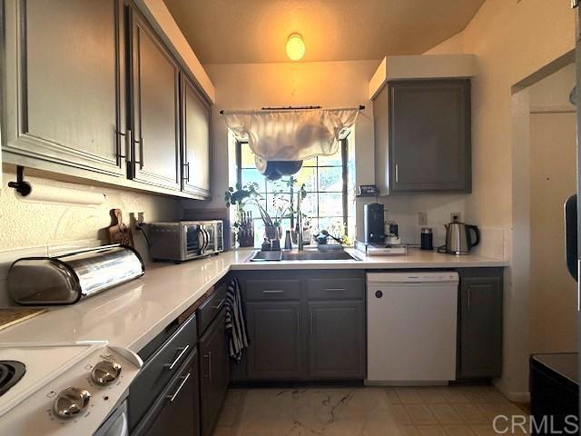 911 Concord Ct, Vista, CA 92081 - kitchen with dishwasher, stove, light countertops, and gray cabinetry