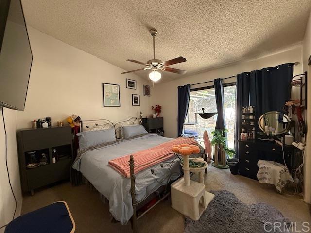 911 Concord Ct, Vista, CA 92081 - bedroom with a textured ceiling, carpet, vaulted ceiling, and ceiling fan