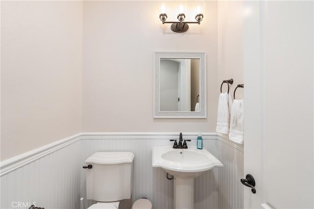 11645 Wiggins Ct, Yucaipa, CA 92399 - bathroom featuring a wainscoted wall and toilet