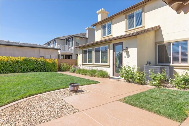 11645 Wiggins Ct, Yucaipa, CA 92399 - back of house with stucco siding and a chimney