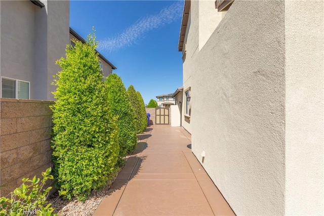 11645 Wiggins Ct, Yucaipa, CA 92399 - view of home's exterior with stucco siding and a gate