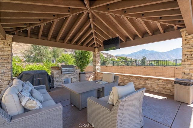 11645 Wiggins Ct, Yucaipa, CA 92399 - view of patio featuring exterior kitchen, a mountain view, and outdoor lounge area