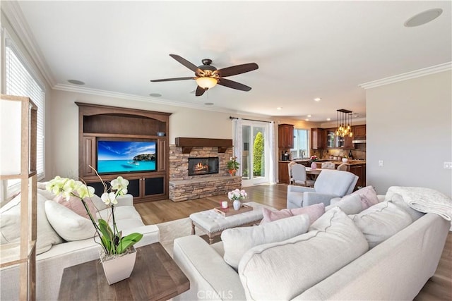 11645 Wiggins Ct, Yucaipa, CA 92399 - living area with light wood-style floors, a fireplace, a ceiling fan, ornamental molding, and recessed lighting
