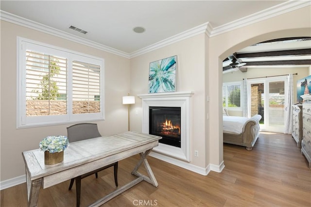 11645 Wiggins Ct, Yucaipa, CA 92399 - office with light wood finished floors, crown molding, a glass covered fireplace, a ceiling fan, and arched walkways