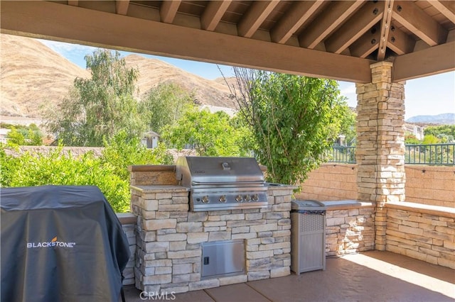 11645 Wiggins Ct, Yucaipa, CA 92399 - view of patio / terrace featuring an outdoor kitchen and a mountain view