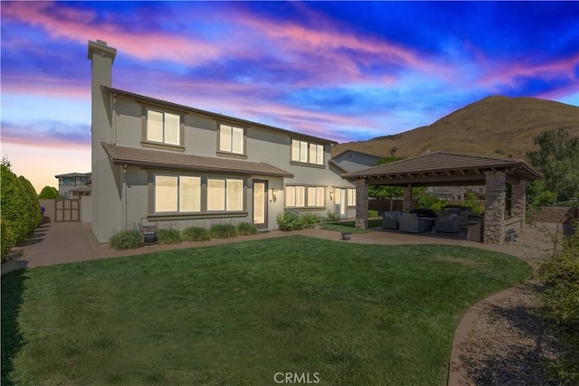 11645 Wiggins Ct, Yucaipa, CA 92399 - back of house featuring an outdoor living space, a gazebo, a patio area, stucco siding, and a chimney