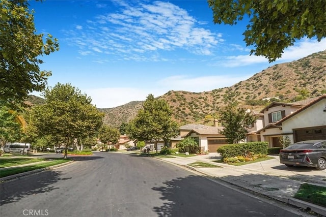 57 Mountain Laurel Way, Azusa, CA 91702 - view of asphalt street featuring a mountain view, sidewalks, curbs, and a residential view