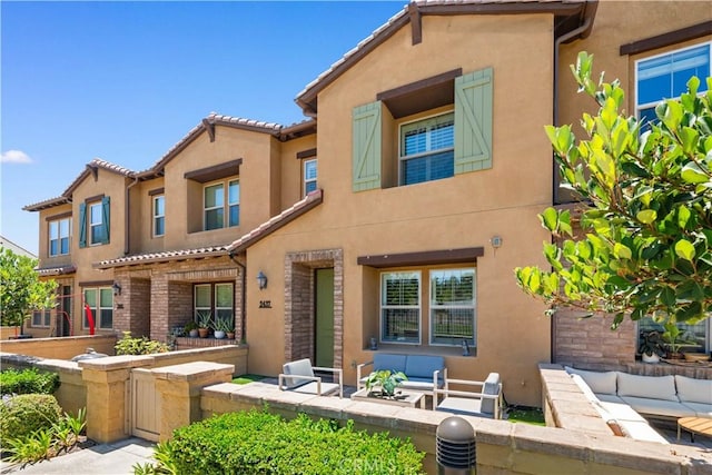 2437 Sanabria Ln, Brea, CA 92821 - mediterranean / spanish-style home featuring an outdoor living space, stucco siding, and a tile roof