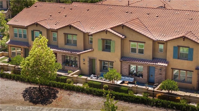 2437 Sanabria Ln, Brea, CA 92821 - view of front of property featuring a tiled roof, a fenced backyard, stucco siding, and a patio