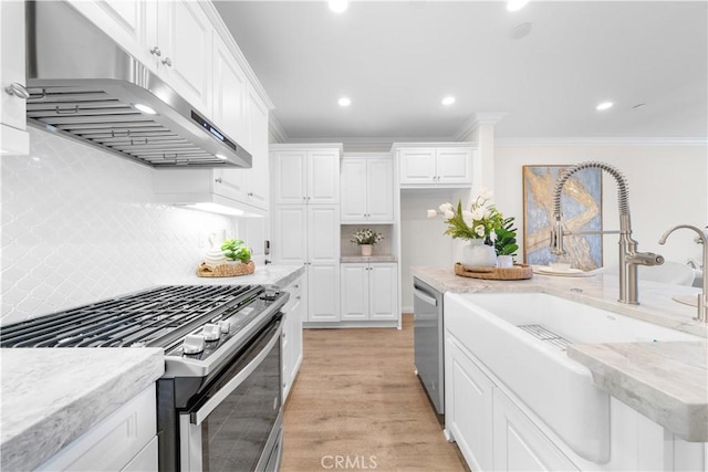 2437 Sanabria Ln, Brea, CA 92821 - kitchen featuring under cabinet range hood, appliances with stainless steel finishes, crown molding, white cabinetry, and backsplash