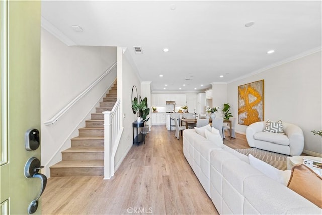 2437 Sanabria Ln, Brea, CA 92821 - living room with recessed lighting, light wood finished floors, stairs, and crown molding