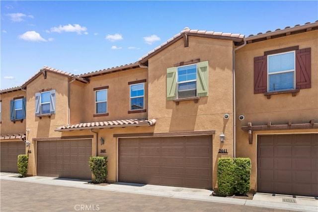 2437 Sanabria Ln, Brea, CA 92821 - mediterranean / spanish house with a tile roof, stucco siding, and an attached garage