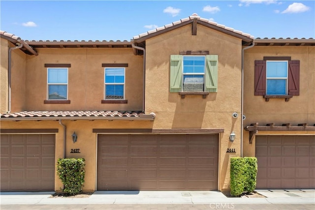 2437 Sanabria Ln, Brea, CA 92821 - mediterranean / spanish house featuring a tile roof, stucco siding, and an attached garage