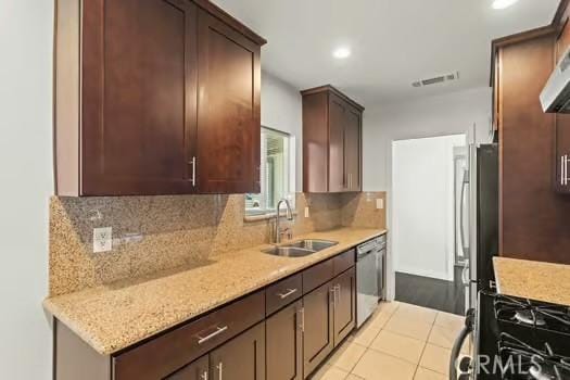 4775 Beverly Ct, Riverside, CA 92506 - kitchen with stainless steel appliances, recessed lighting, tasteful backsplash, dark brown cabinets, and extractor fan