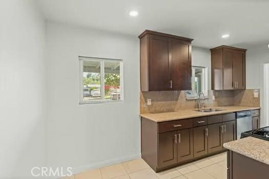 4775 Beverly Ct, Riverside, CA 92506 - kitchen featuring light countertops, tasteful backsplash, recessed lighting, light tile patterned floors, and stainless steel dishwasher
