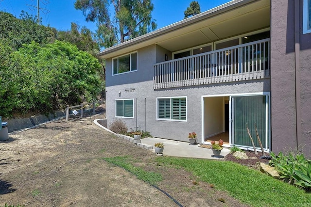 6229 Caminito Basilio, San Diego, CA 92111 - back of house with stucco siding and a balcony