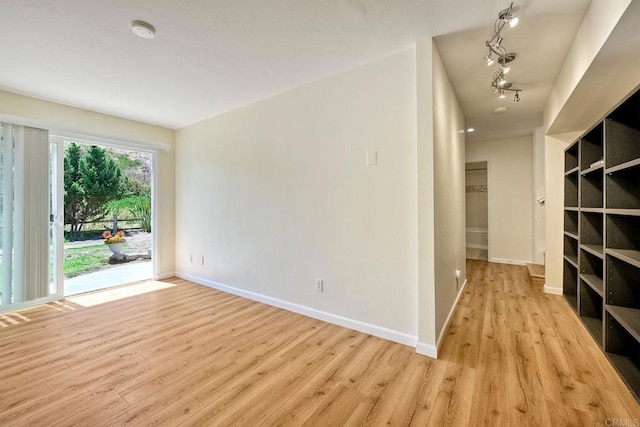6229 Caminito Basilio, San Diego, CA 92111 - unfurnished room with a smoke detector, rail lighting, and wood finished floors