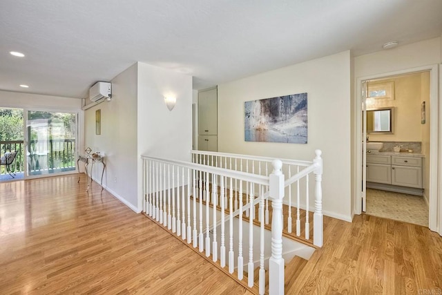 6229 Caminito Basilio, San Diego, CA 92111 - hall featuring an upstairs landing, a wall unit AC, wood finished floors, and recessed lighting