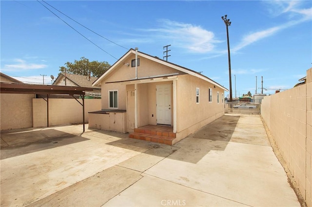 1435 E Colon St, Wilmington, CA 90744 - rear view of house with a fenced backyard, a patio, and stucco siding