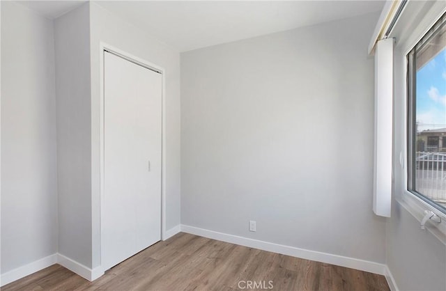 1435 E Colon St, Wilmington, CA 90744 - unfurnished bedroom featuring light wood-style flooring and a closet