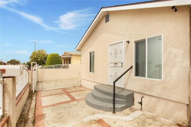 1435 E Colon St, Wilmington, CA 90744 - view of side of property with stucco siding, entry steps, and a patio area