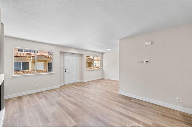 43441 30th St W Unit 3, Lancaster, CA 93536 - unfurnished living room with light wood-style floors and recessed lighting
