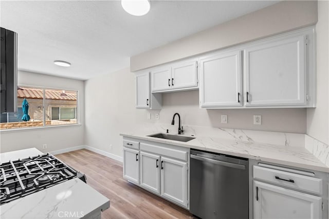43441 30th St W Unit 3, Lancaster, CA 93536 - kitchen featuring dishwasher, white cabinetry, light wood-style flooring, light stone countertops, and black range with gas cooktop