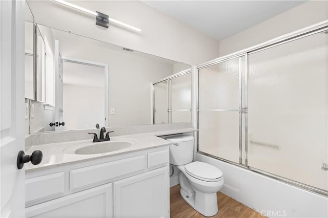 43441 30th St W Unit 3, Lancaster, CA 93536 - full bathroom with vanity, wood finished floors, and bath / shower combo with glass door
