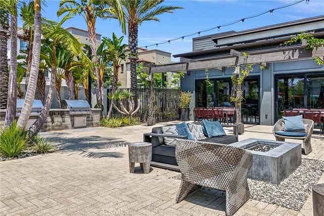 791 S Mosaic St, Anaheim, CA 92805 - view of patio with an outdoor kitchen and an outdoor living space with a fire pit