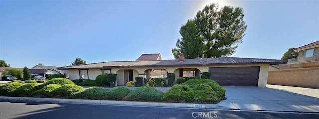12546 Rain Shadow Rd, Victorville, CA 92395 - ranch-style home featuring stucco siding, concrete driveway, an attached garage, and a chimney