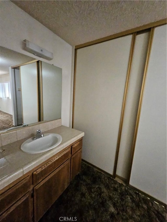 12546 Rain Shadow Rd, Victorville, CA 92395 - bathroom featuring vanity and a textured ceiling