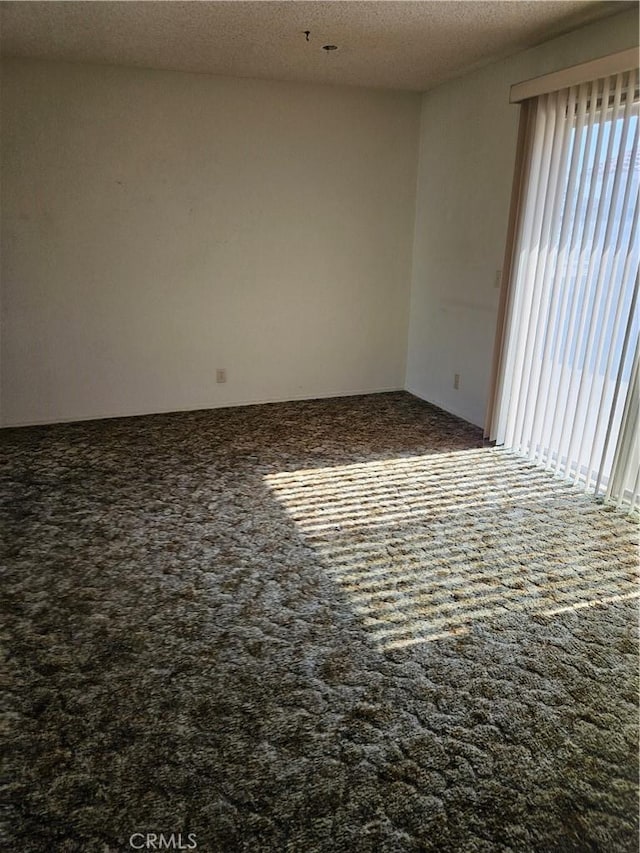 12546 Rain Shadow Rd, Victorville, CA 92395 - carpeted empty room featuring a textured ceiling