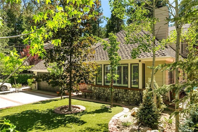 514 Riviera Dr, Lake Arrowhead, CA 92352 - exterior space with a front yard, driveway, stone siding, a garage, and roof with shingles