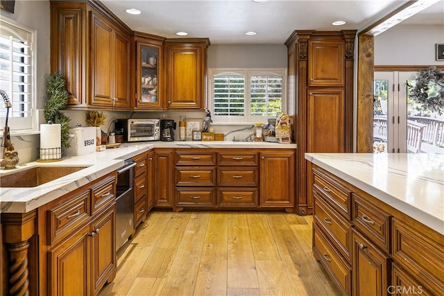 514 Riviera Dr, Lake Arrowhead, CA 92352 - kitchen with brown cabinets, light wood-style flooring, light stone countertops, recessed lighting, and dishwasher