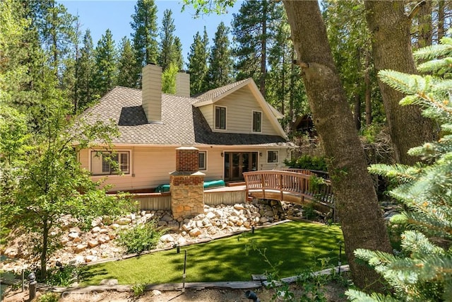 514 Riviera Dr, Lake Arrowhead, CA 92352 - rear view of property with a chimney, a wooden deck, a shingled roof, and a lawn
